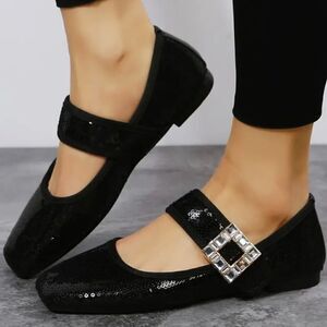 Black sequin flats with crystal and metal strap embellishments.